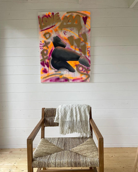 This vibrant contemporary art features a mix of acrylic, oil pastels, and spray paint on a canvas. Here is is hanging up in a beautiful interior.